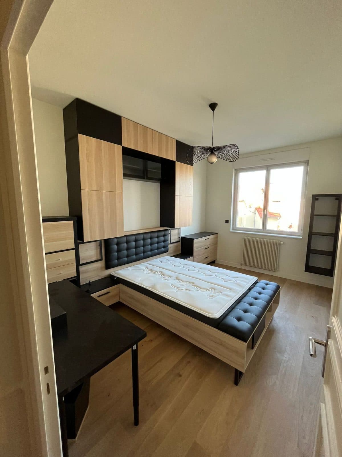 Chambre : meubles sur mesure chêne et noir autour du lit, tête de lit capitonnée, suspension en métal noir